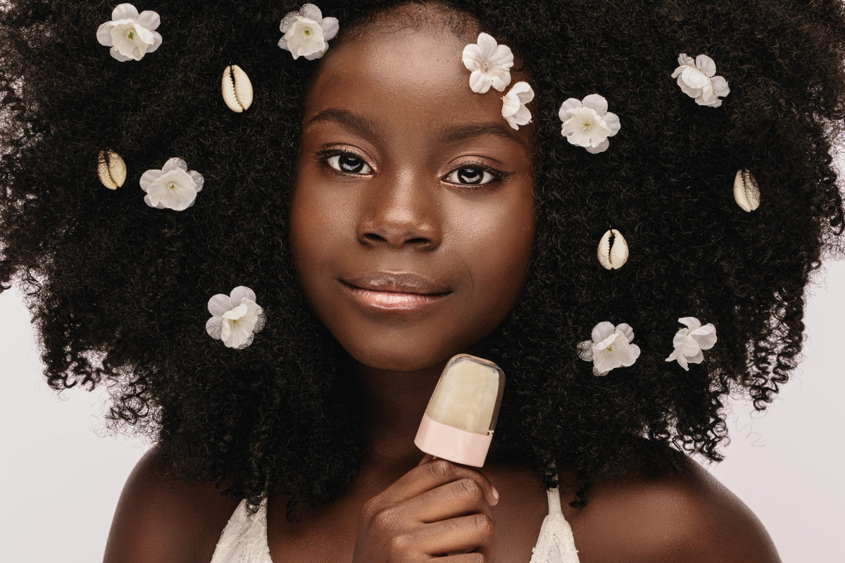 A KUTE girl with flowers in her hair holding a Lipsickel
